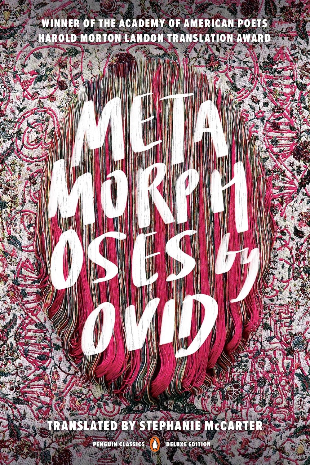 Book cover of Metamorphoses by Ovid translated by Stephanie McCarter. Image of light pink fabric with daintily embroidered images of trees, branches, leaves, feathers, flowers and grapes. Over top the dainty embroidered images, larger images of DNA strands, ovaries, and indistinguishable text have been embroidered in pink thread. In the middle, an oval has been embroidered with a satin stitch with pink and tan thread. The book title has been written in white in the middle of the oval with a photo editing software